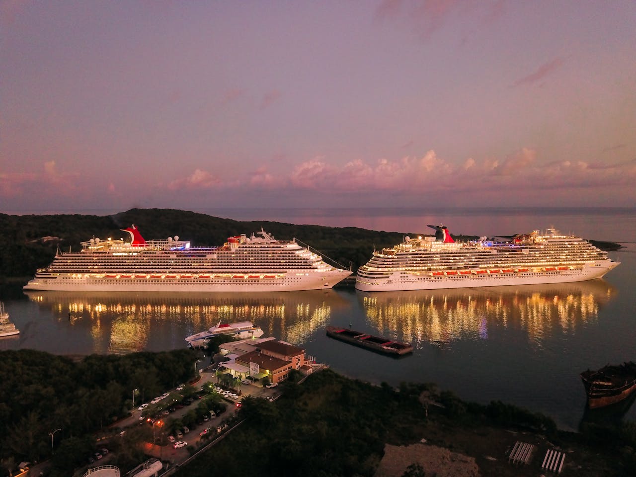 services-03 Two illuminated cruise ships docked at Coxen Hole, Honduras during twilight.